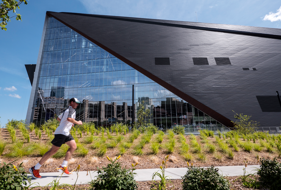 Minneapolis skyline reflected off the US Bank Stadium windows on a bright spring day